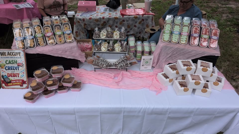 Nana’s Sweet Treats market table filled with individually packaged desserts and chocolate treats